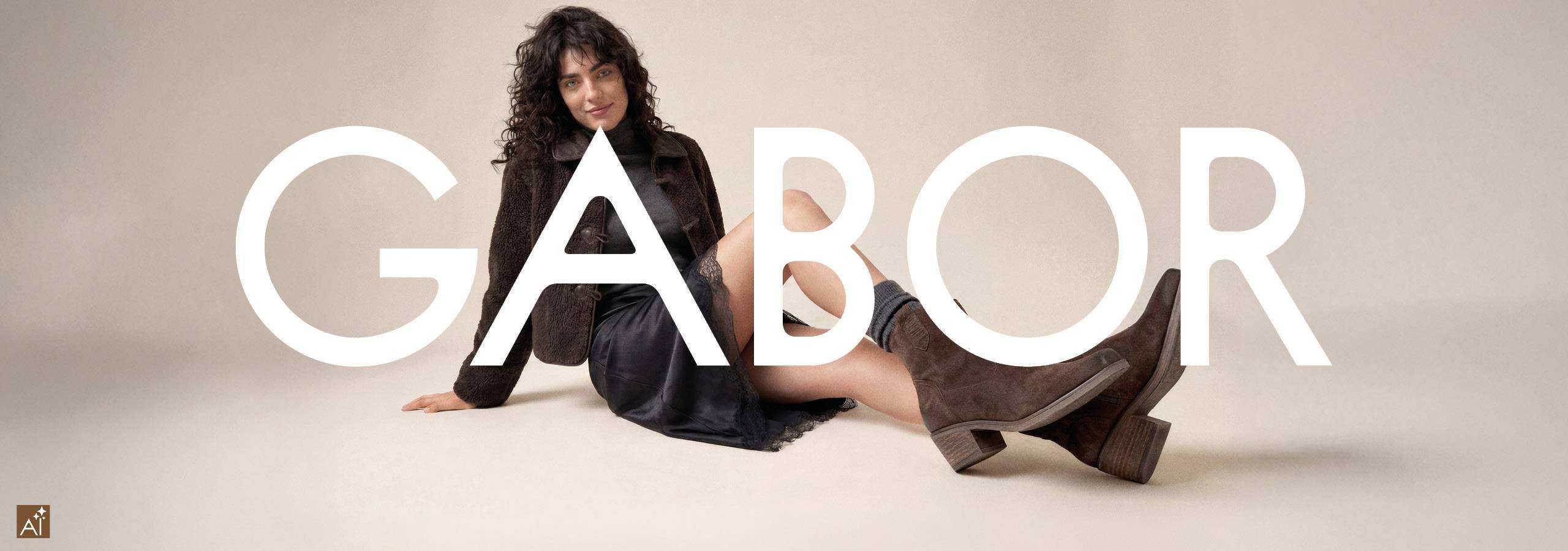 a woman sits on the floor wearing gabor boots behond a Gabor logo